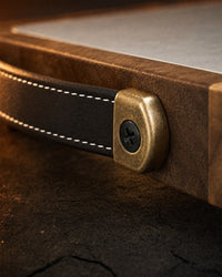 Handle close-up: vegan leather, brass fittings, black screws
